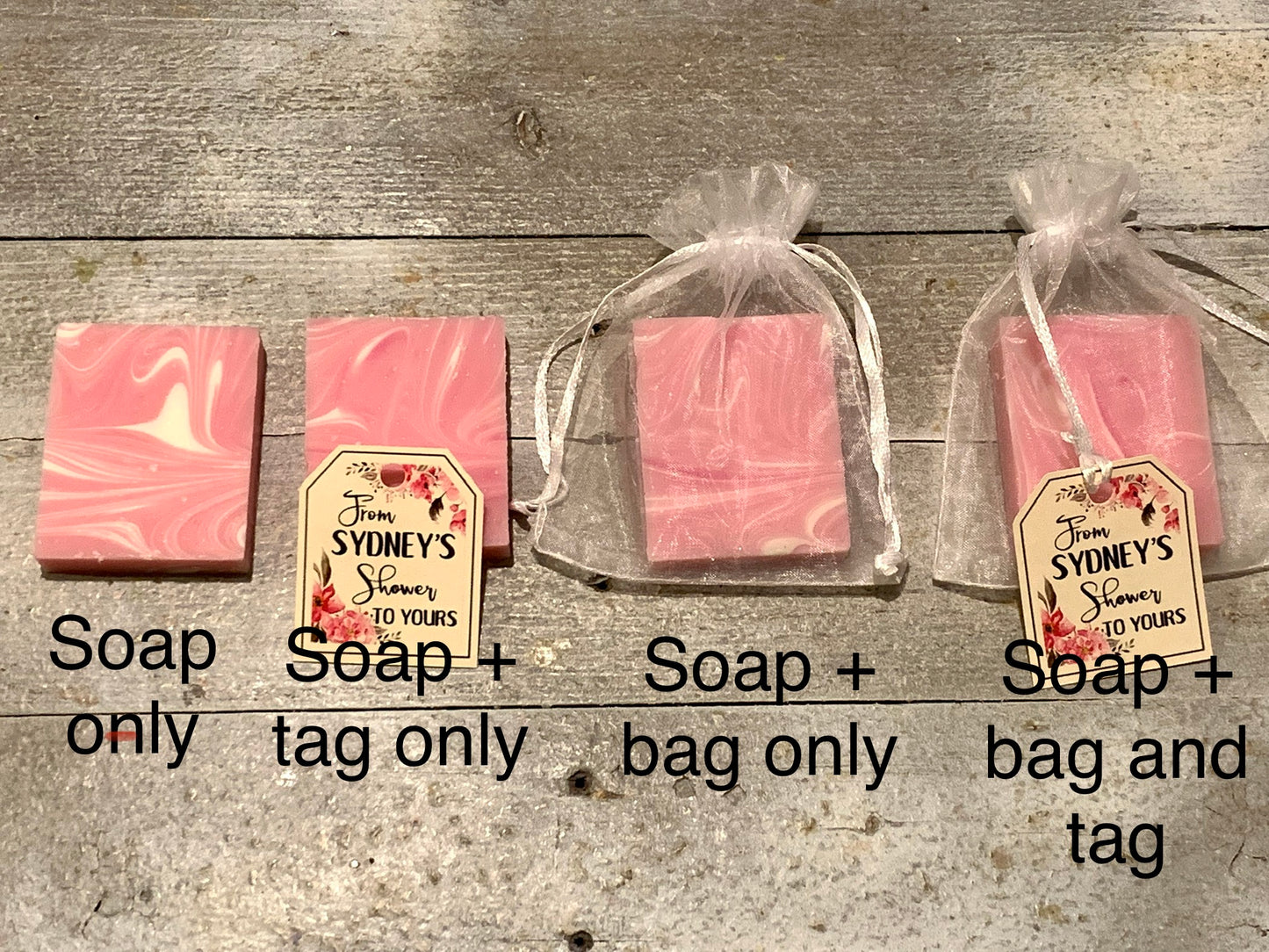 Mini soap shower favors in white mesh bags with pink floral tags