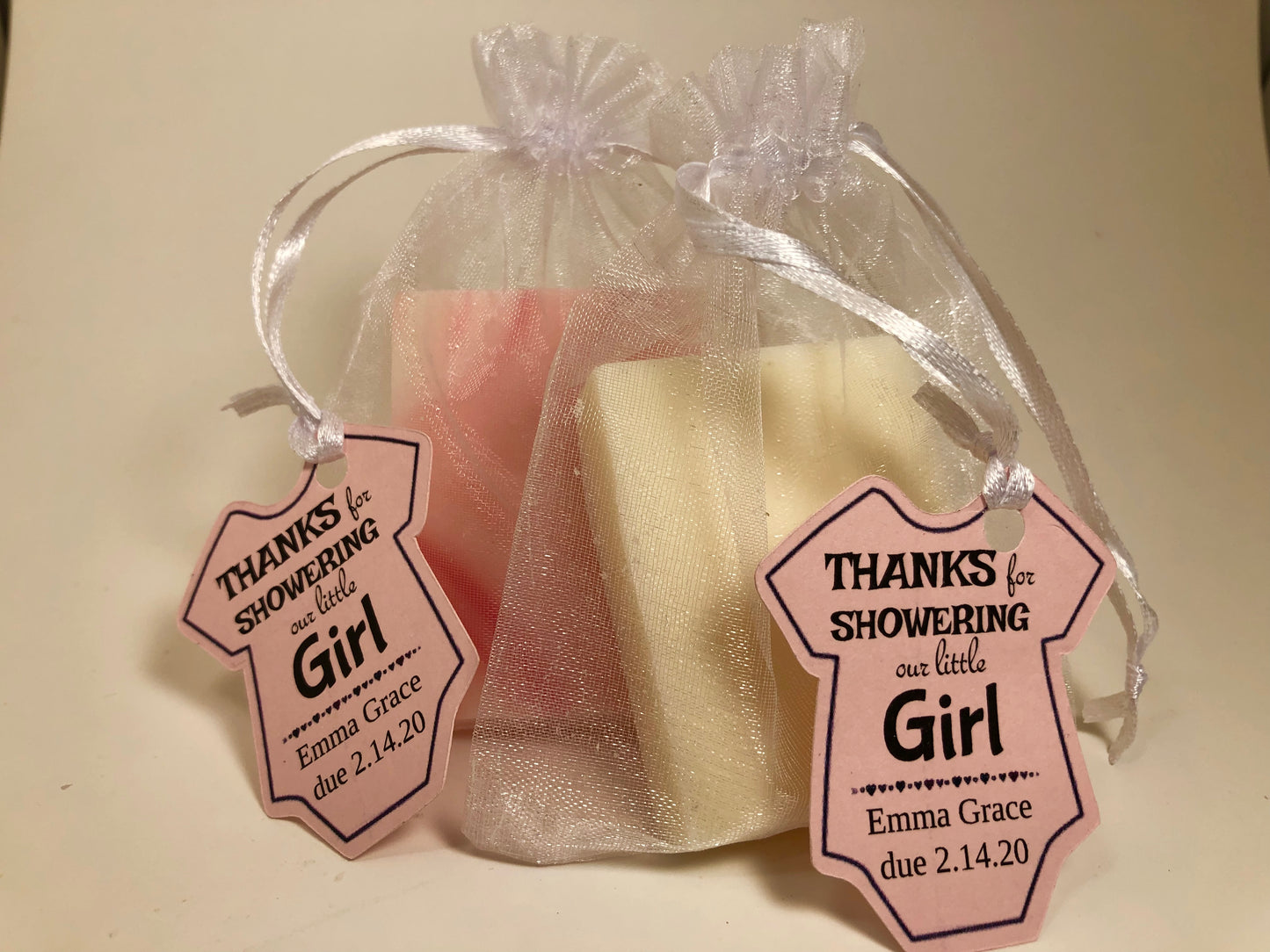 Mini soap shower favors in mesh bags with custom baby onesie tags