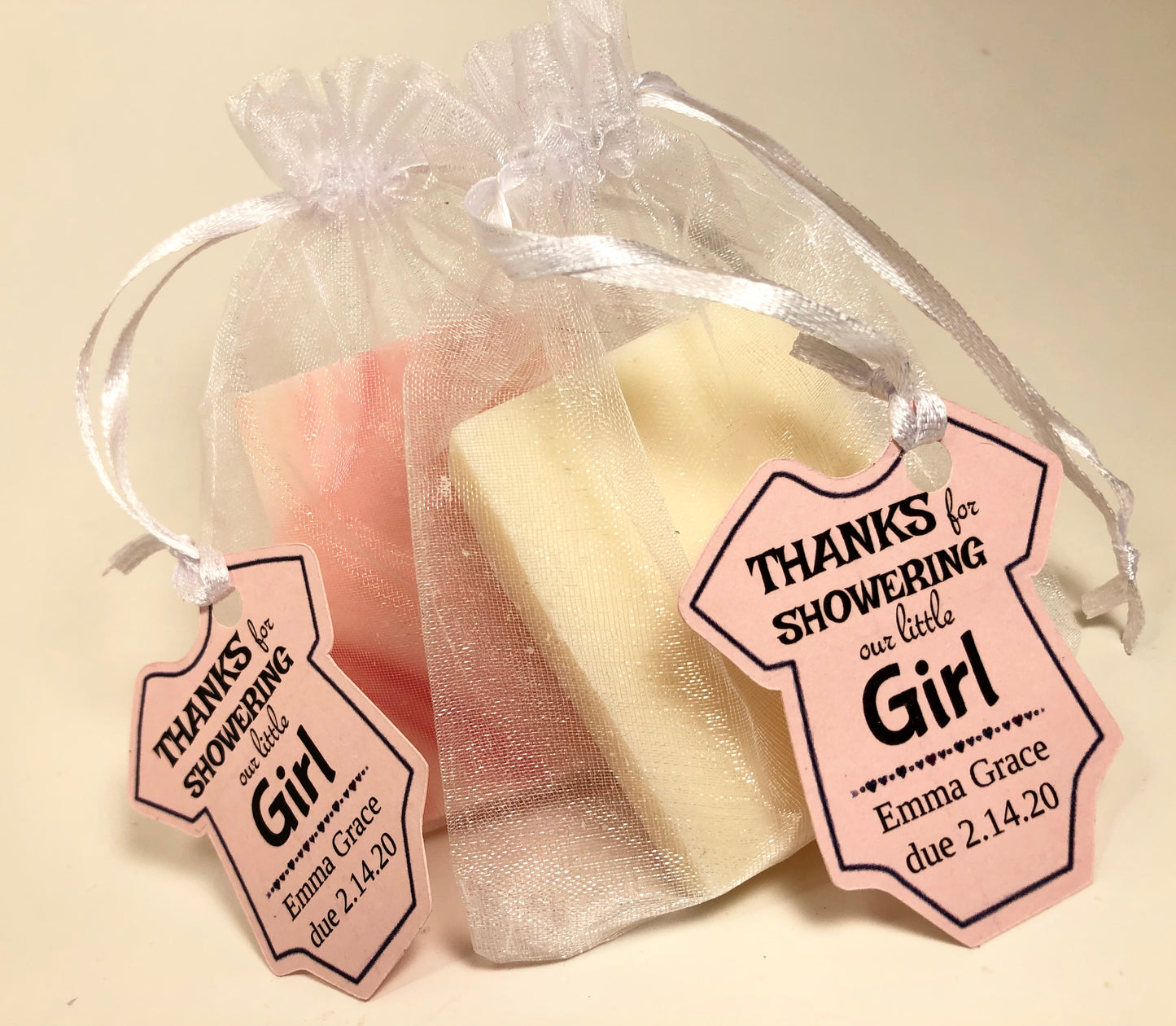 Mini soap shower favors in mesh bags with custom baby onesie tags
