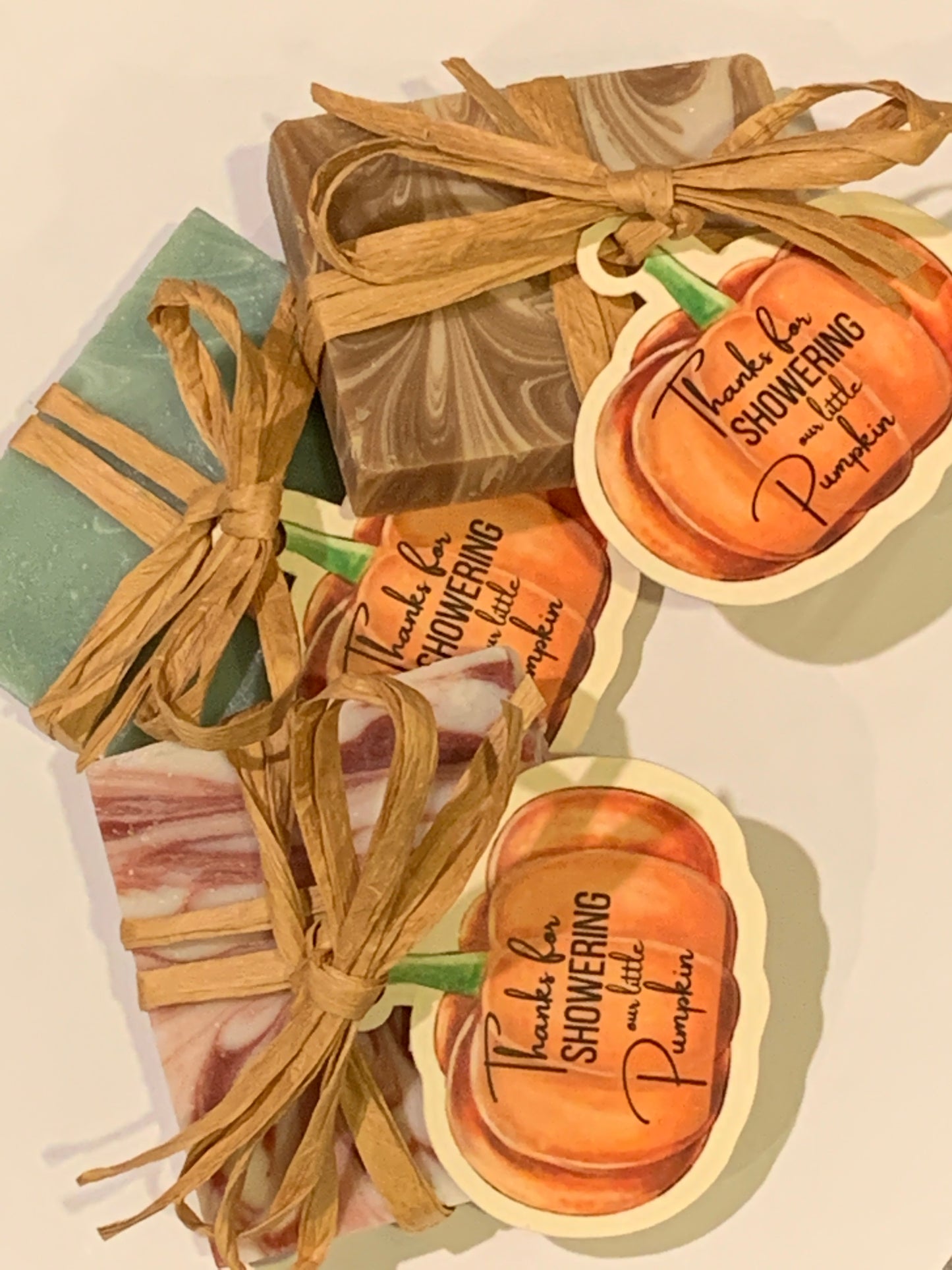 Pumpkin themed mini soaps wrapped in raffia with custom tags